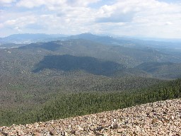 View from the ridgeline to the north northeast (towards Little Castilla and the Sangre de Cristo range in Colorado); forest below is the Kit Carson National Forest.