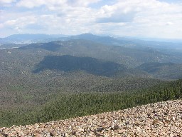 View from the ridgeline to the north northeast (towards Little Castilla and the Sangre de Cristo range in Colorado); forest below is the Kit Carson National Forest.